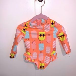Long sleeve, one piece popsicle print swimsuit.